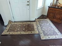 Both rugs laid near doorway showing overall pattern and size