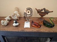 Group shot of all eight bird figurines on shelf