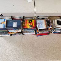 Stacks of hardcover books under folding table