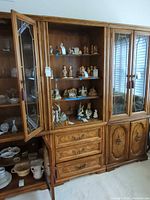 Full view of cabinet showing glass doors, shelves, drawers and side cabinet