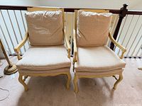 Front view of both caned back chairs with cushions
