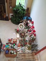Full layout of Christmas decorations including ornaments, figurines, sled, sleigh, candles, plate, ceramic trees and wrapping paper