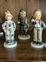 Front view of three Hummel figurines