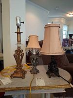 All three metal table lamps shown together on small table