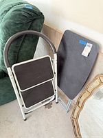 Stool and tray table folded, showing materials, colors, overall condition