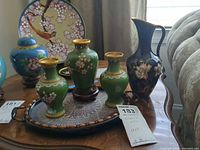 Group view of three green vases on enamel tray with cobalt pitcher