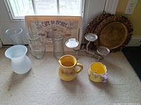 Group shot showing all vases, pitcher, mug, candle holder, Café du Monde tray, two round trays