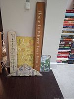 All five wall décor items leaning against wall