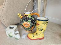 Group shot of sunflower jug, boot planter, tissue box cover and cup