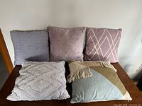 Five pillows arranged on table front view