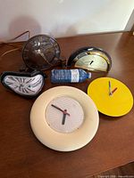 Group shot of five clocks on tabletop