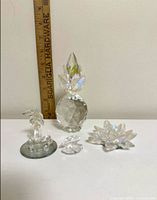 All four crystal pieces beside ruler
