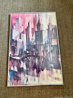 Full view of framed abstract cityscape painting