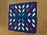 front side of quilt showing navy field with diamond star pattern