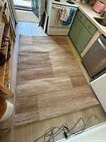 Full view of rug in kitchen setting showing overall size and pattern