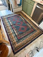 Full rug on floor showing overall design and fringe
