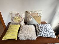 Front view of all five pillows on table