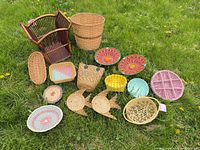 All 14 woven pieces displayed on grass