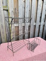 Tall 3-tier rack and smaller vinyl rack on table
