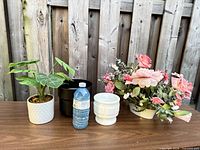 All four items lined up with water bottle for scale