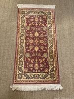 Full view of the runner rug showing complete design, colors, and fringe ends