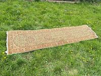 Full view of entire runner rug laid on grass