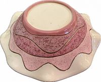 Bottom view showing pink speckled layers and gold trim