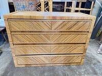 Front view showing four drawers and chevron rattan pattern