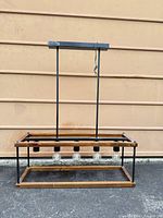 Front view of rectangular wood and metal chandelier with five bulb sockets