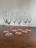 Set of eight clear-bowl, pink-stem champagne flutes