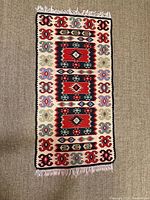 Full view of kilim runner on floor showing overall pattern and fringe