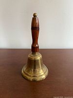 Full view of brass bell standing upright