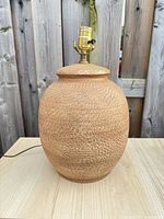 Front view of textured tan/brown ceramic lamp base with socket