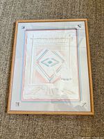 front view of framed embossed handmade paper artwork