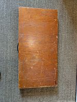 Closed wooden display case top view showing scratches