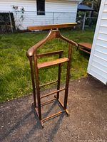 Full frontal view of wooden valet stand
