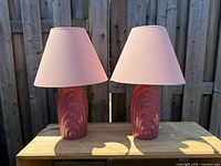 Front view of both pink ceramic table lamps with shades