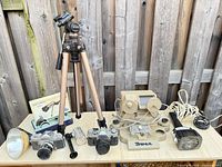 Full lot view: two SLR cameras, tripod, Tower viewer-splicer, flashes, Pan-Cinor box, extra lens