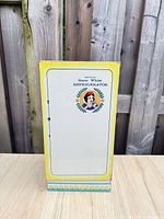 Front view closed showing Snow White graphic and yellow border