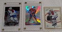 Front view of three Saku Koivu Upper Deck hockey cards in screw-down cases