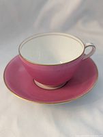 Teacup on saucer front view showing color and trim