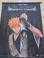 Front view of full wall scroll showing characters and logo with hanging rods