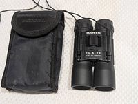 Bushnell 10x25 binoculars with black pouch displayed side by side