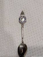 Full view of collector spoon showing enamel crest and bowl