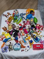 All toys laid out on a white surface showing variety and condition