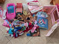 Entire lot showing dolls, furniture pieces, boxes and clothing