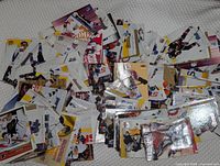 Pile of over 200 Fleer hockey trading cards spread out showing assorted players and card designs
