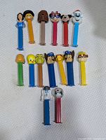 All 13 PEZ dispensers laid out showing character heads and coloured stems