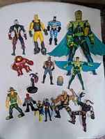 Group shot showing all fifteen assorted superhero action figures on white background