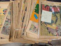 Stack of coverless comic interiors with one bagged Batman #203 showing intact cover